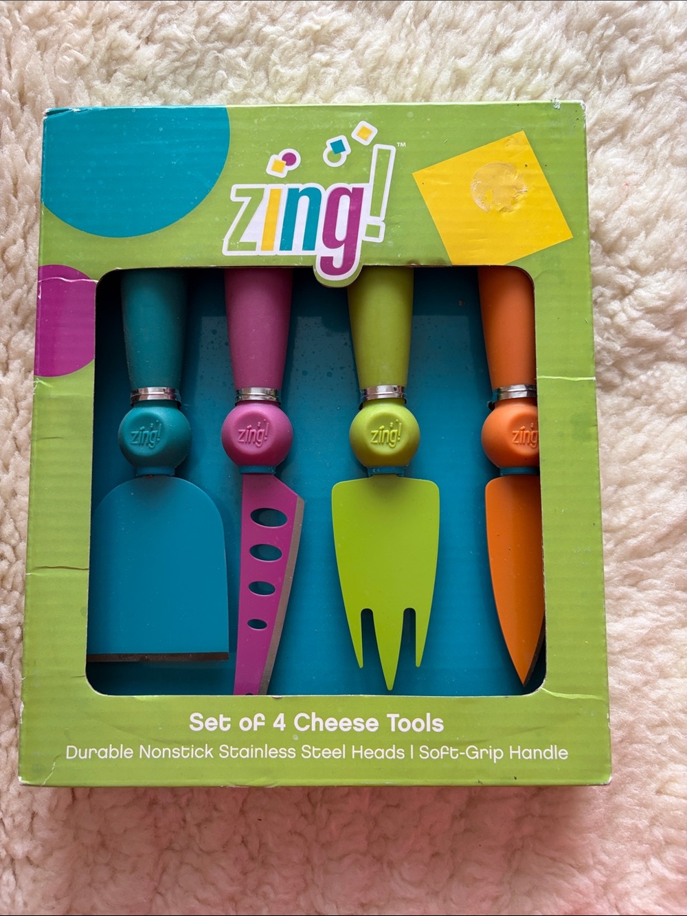 Ing colorful 4-piece cheese tool set in teal, pink, lime, orange